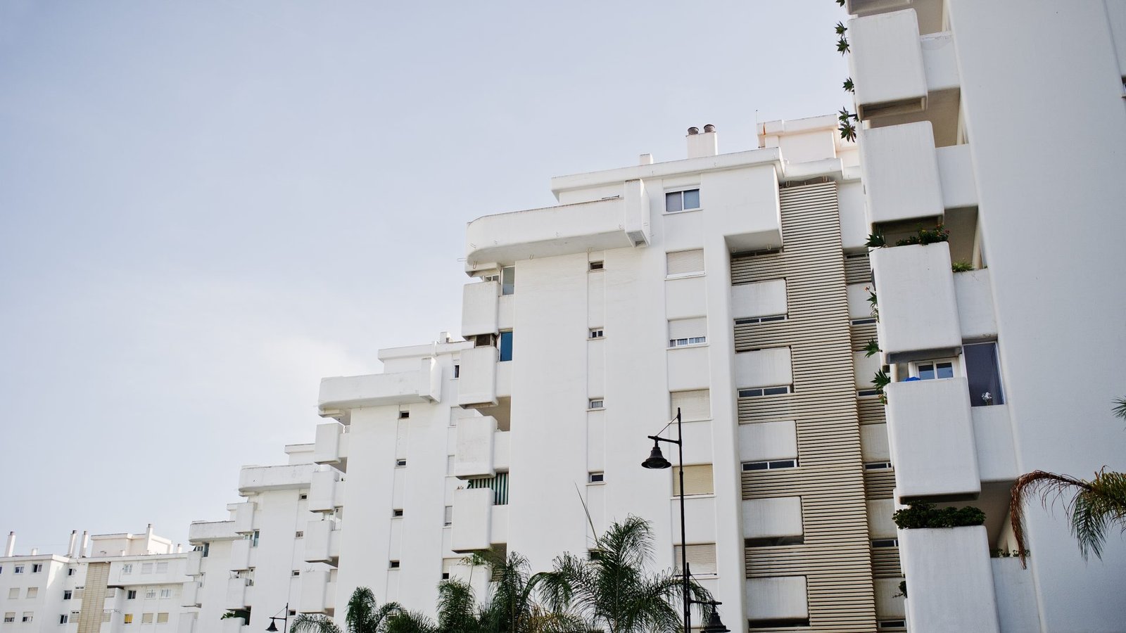 Streets with architecture of the resort town buildings and tropical greenery.